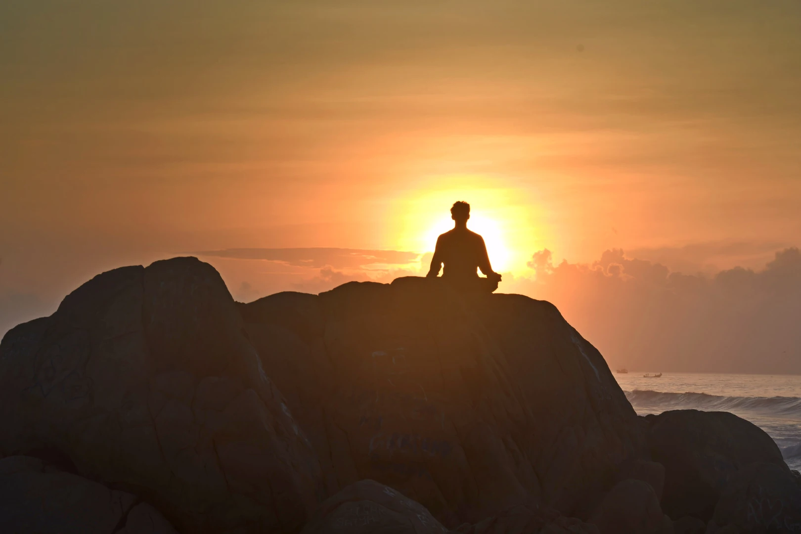 A person sitting quietly outdoors at sunrise